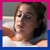 Screenshot of Dana Scully from The X-Files with her eyes closed in a bubble bath. She is surrounded by a bisexual flag border.