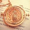 A necklace with a gold pendant, specifically an hourglass, capable of traveling through time.