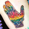 tattoo of a rainbow-coloured Vulcan greeting hand designed to look like stained glass